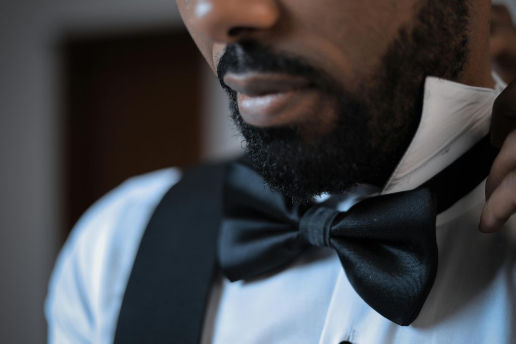 Close-up shot of a man wearing a black bow tie, showcasing style and elegance.