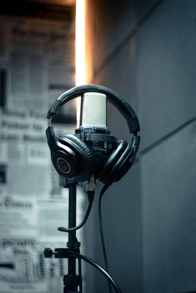Close-up of a microphone with headphones in a modern recording studio.