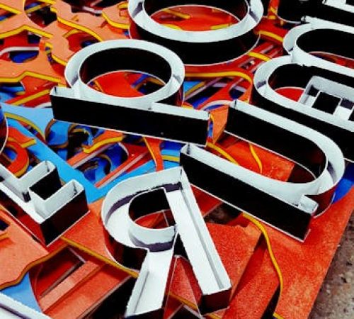 pexels-photo-1058100-1058100 Vibrant neon letters arranged artistically, showcasing a unique signage design.